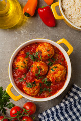 Chicken meatballs with tomato sauce. Served with rice.