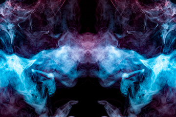 A multi-colored pattern of blue and pink smoke of a mystical shape in the form of a face and a ghost's head or a strange creature on a black isolated background. Abstract pattern in of waves and steam