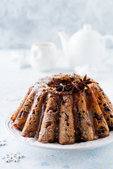Traditional Christmas fruit cake, pudding on white plate. Top view. Copy space.