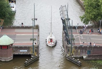 Fototapeta na wymiar Leeuwarden, the Netherlands, 10 june 2018: Open bridge in the dutch waterways during the tourist season on june 10, 2018 in Leeuwarden, the Netherlands