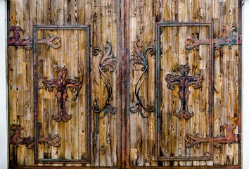 Old wooden gate in a white stone fence 