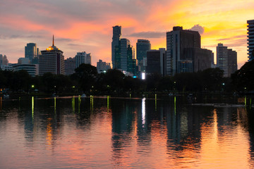 Fototapeta premium Bangkok city beautiful skyline at dusk, viewing from Lumphini Park with tourist are traveling here.
