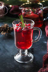 Christmas cranberry drink garnish rosemary and fir branches on black . Close up. Xmas drink.