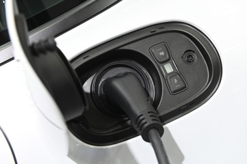 Close up of the hybrid car electric charger station with power supply plugged into