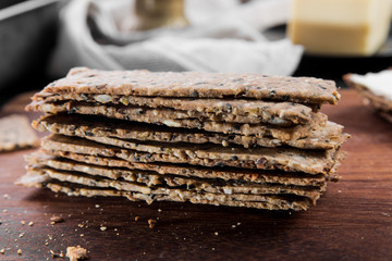 Useful rye crispbread on a wooden board against a dark background
