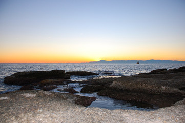 Fototapeta na wymiar Beautiful twilight sky, coast with rocks in the Mediterranean Sea and the beach in the city of Side, Turkey