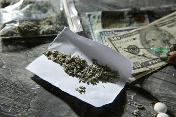 Drugs with money on grey background. Concept of addiction
