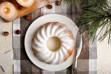 Plate with delicious Christmas cake on table