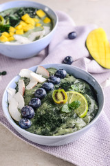 Bowls with tasty spirulina smoothies on grey table