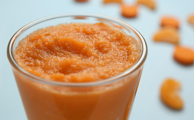 Glass of tasty orange smoothie, closeup
