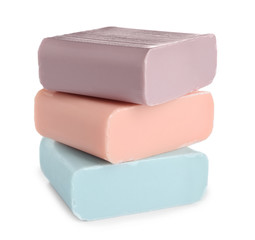 Stack of different soap bars on white background
