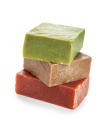 Stack of different soap bars on white background