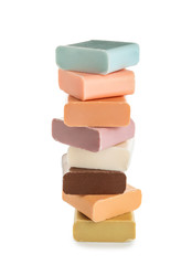Stack of different soap bars on white background