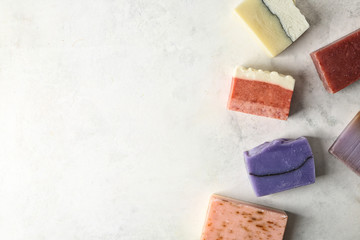 Different soap bars on light table, top view - obrazy, fototapety, plakaty
