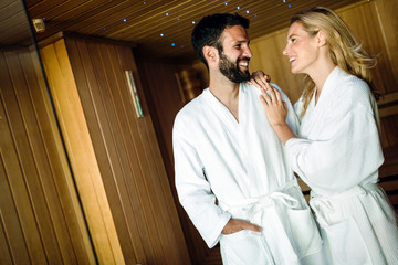 Attractive happy couple relaxing in spa center