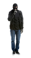 Fototapeta premium Male thief showing silence gesture on white background