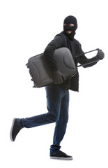 Male thief with suitcase on white background