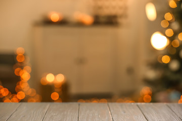 Closeup view of wooden table against blurred Christmas interior