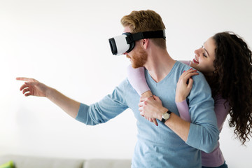 Attractive young couple trying virtual reality headset