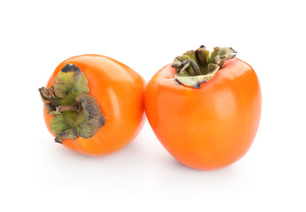 Ripe persimmons on white background