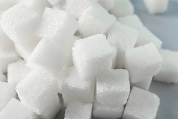 Heap of refined sugar cubes on table, closeup