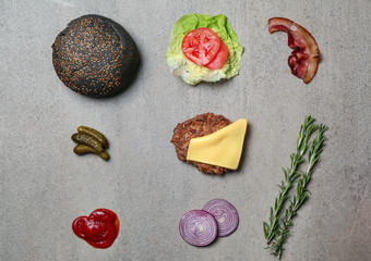 Ingredients for burger on grey background, flat lay