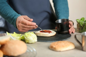 Male chef preparing burger in kitchen