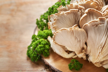 Fresh mushrooms on wooden board, closeup
