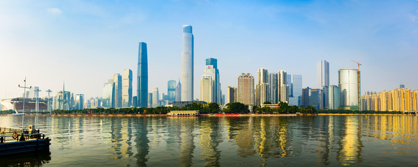 Modern cityscape of Guangzhou reflected in the Perl river at sunset
