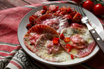 Plate with tasty ravioli on table, closeup