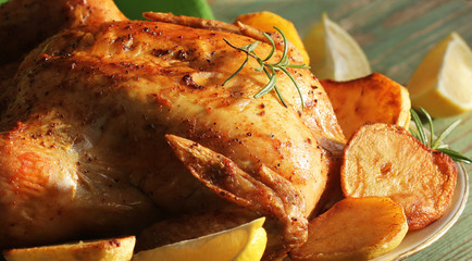 Whole roasted chicken with potatoes and lemon