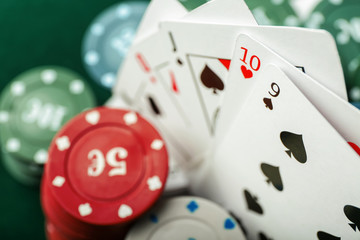 Chips with cards for poker game, closeup