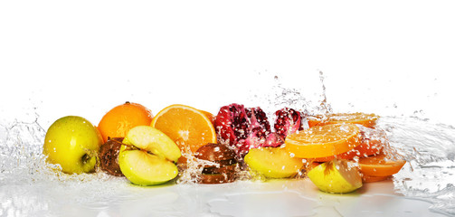 Fresh fruits with splashing water on white background