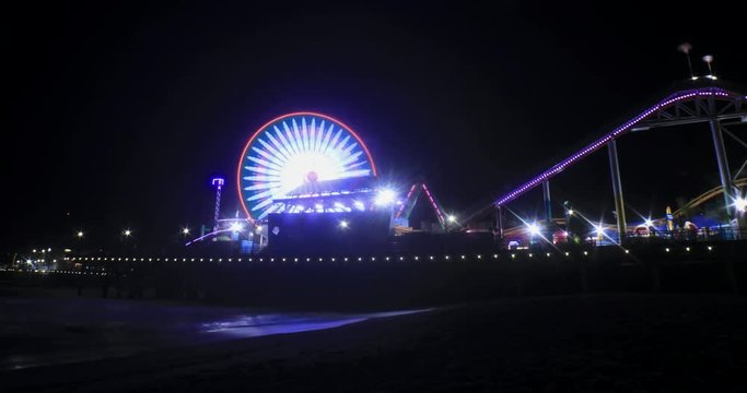 Looping 4k clip of waves and rides on Santa Monica pier at night