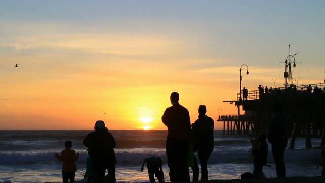 Silhouettes watching amazing sunset over the Pacific Ocean