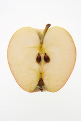 GREEN APPLE SLICED IN HALF ON WHITE BACKGROUND