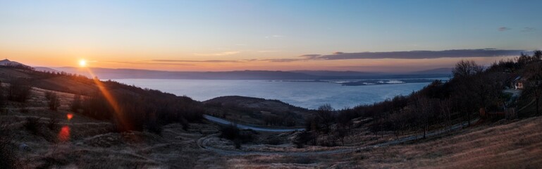 Fototapeta na wymiar Panorama of sunset in Romania. Danube River, Clean sky.
