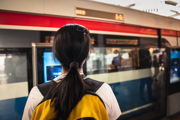 Asian Woman are waiting train in SkyTrain Station in Bangkok