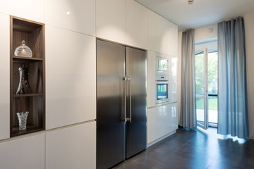 Interior of modern kitchen with built-in appliances