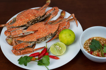 Blue crabs closeup with Thai seafood dipping sauce on a plate