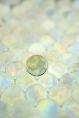 LIGHT SHINING THROUGH TRANSPARENT COLOURED GLASS BALLS