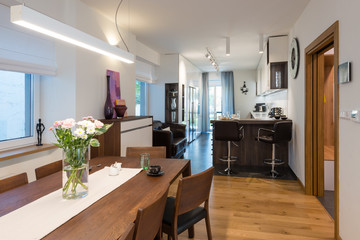 Dining table next to kitchen in modern house