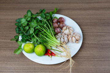 Herb and ingredients for spicy Thai soup Tom Yam on white plate