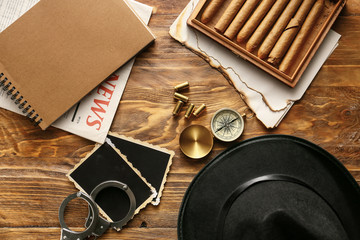 Flat lay composition with different items for detective on wooden background