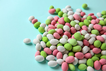 Tasty sweet candies on color background