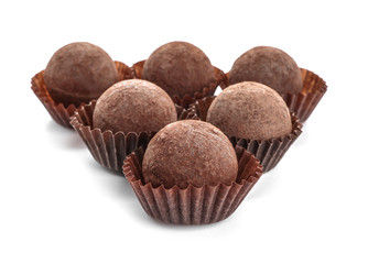 Tasty chocolate truffles on white background