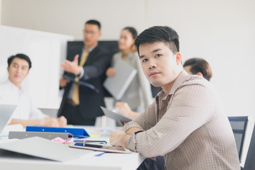 A group of Asian businessmen are discussing their work. portrait of male employee while presidents and secretaries were present.