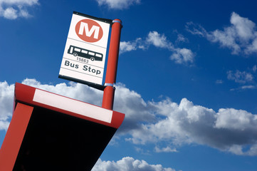 BUS SHELTER AND BUS STOP SIGN WITH BLUE SKY BACKGROUND