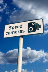 ROAD TRAFFIC SPEED CAMERA WARNING SIGN WITH BLUE SKY BACKGROUND