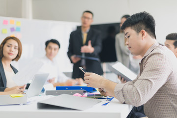 A group of Asian businessmen are discussing their work. portrait of male employee while presidents and secretaries were present.